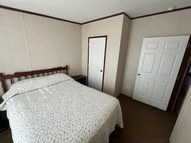 a bed sitting in a bedroom next to a window