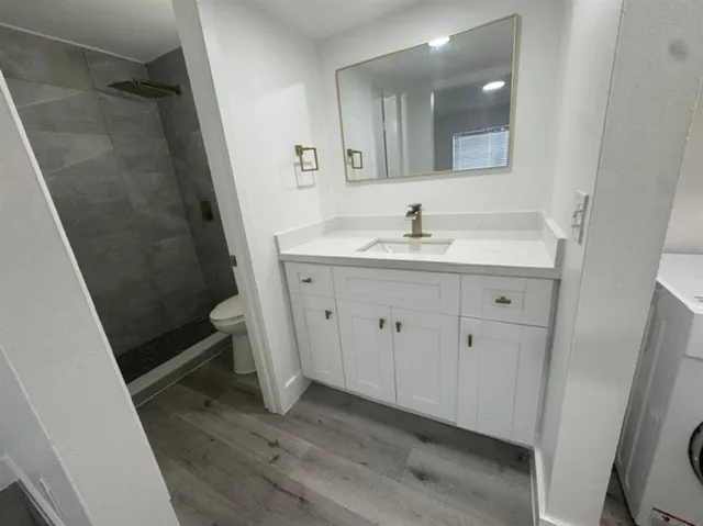 a bathroom with a sink a toilet and a mirror