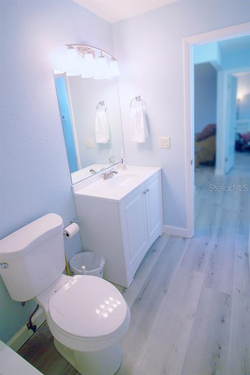 400 Base, Unit 225 Venice, FL 34285 - Photo 11 of 20 a bathroom with a sink a toilet a mirror and vanity