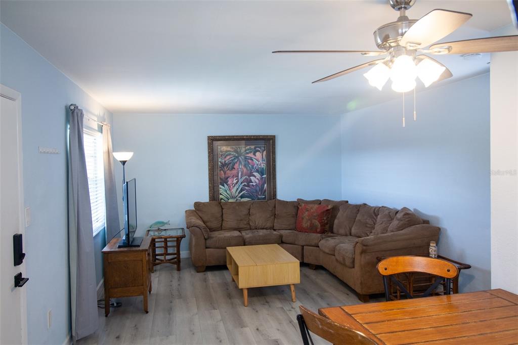 400 Base, Unit 225 Venice, FL 34285 - Photo 2 of 20 a living room with furniture and a large mirror