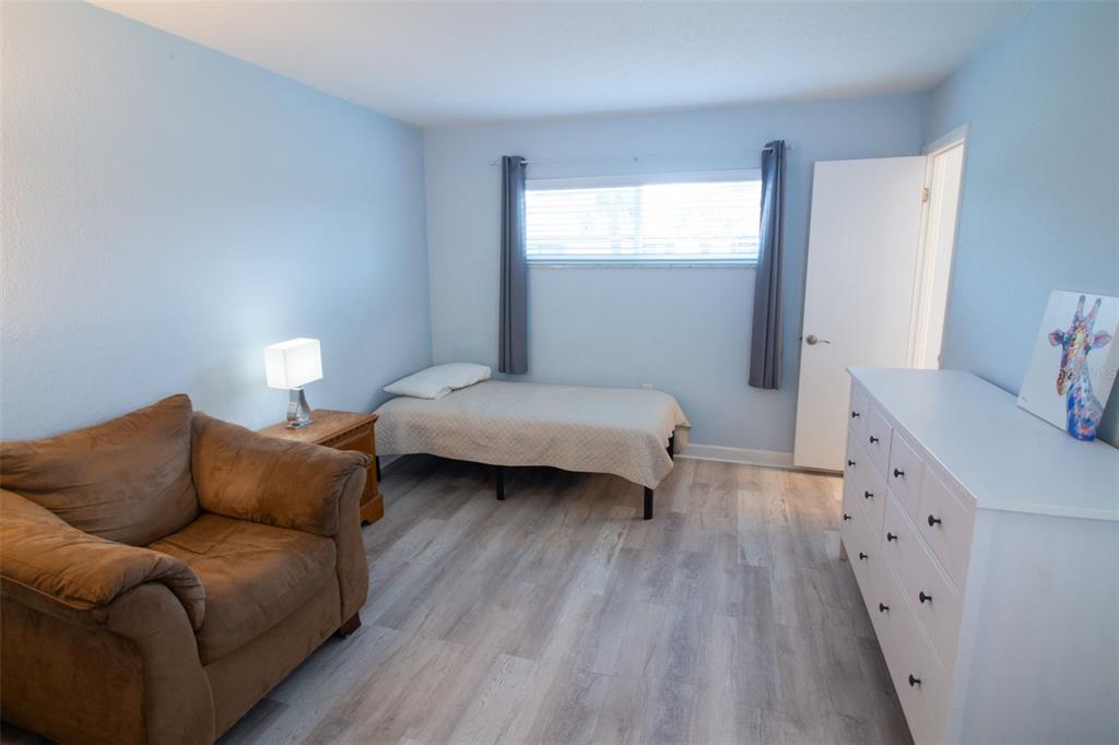400 Base, Unit 225 Venice, FL 34285 - Photo 5 of 20 a bedroom with furniture and a wooden floor
