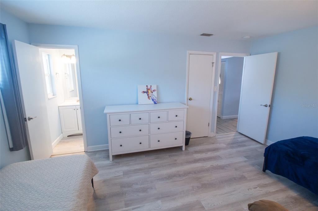 400 Base, Unit 225 Venice, FL 34285 - Photo 6 of 20 a view of a bedroom with furniture and wooden floor