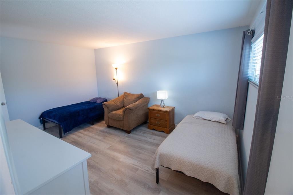 400 Base, Unit 225 Venice, FL 34285 - Photo 7 of 20 a bedroom with bed and a lamp