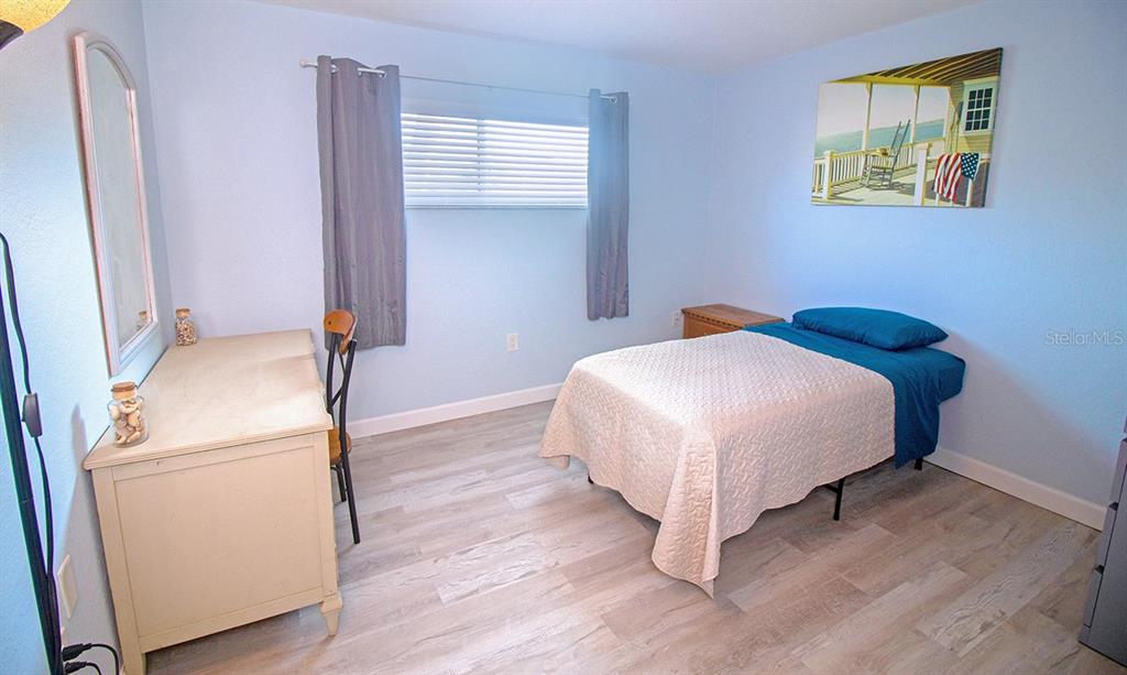 400 Base, Unit 225 Venice, FL 34285 - Photo 9 of 20 a bedroom with a bed and a window