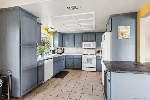 a kitchen with a sink cabinets and window