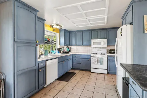 a kitchen with stainless steel appliances granite countertop a refrigerator and a stove