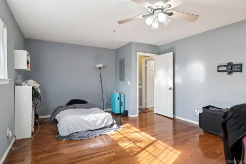 a bedroom with a bed and wooden floor