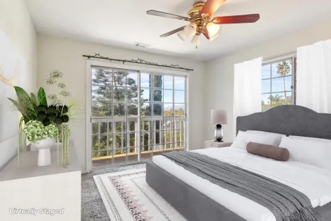 a bedroom with a large bed and a potted plant