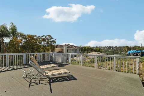 a view of roof deck with two chairs and wooden floor