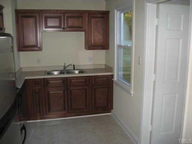 801 Colleton Road Raleigh, NC 27610 - Photo 12 of 12 a bathroom with a sink and cabinets