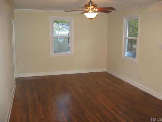 801 Colleton Road Raleigh, NC 27610 - Photo 3 of 12 a view of an empty room with wooden floor and a window
