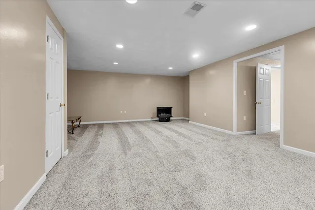 an empty room with windows and closet