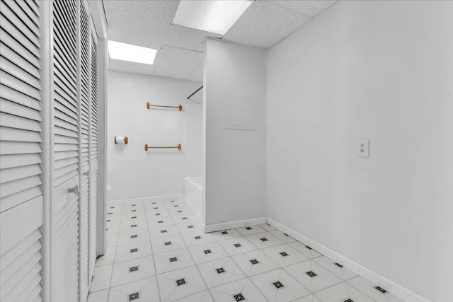 a balcony with wooden floor and trees in the back