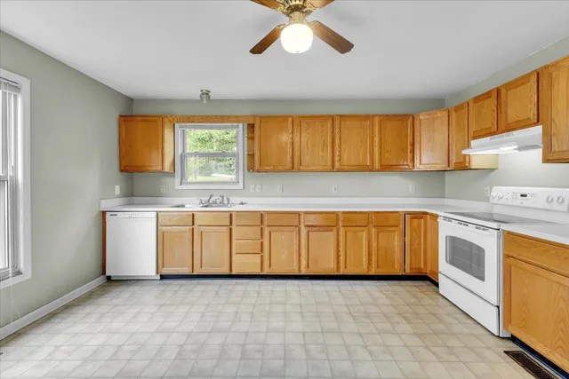 a kitchen with a sink cabinets and window