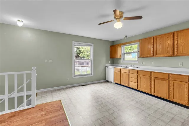 a kitchen with a sink cabinets and window