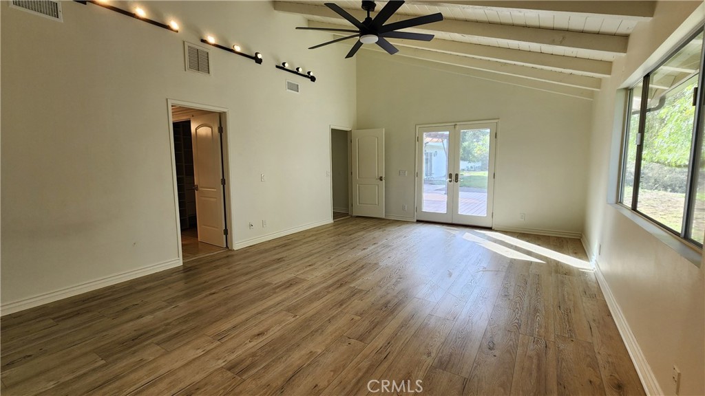 5845 Hilltop Road Hidden Hills, CA 91302 - Photo 11 of 20 a view of an empty room with wooden floor and a window