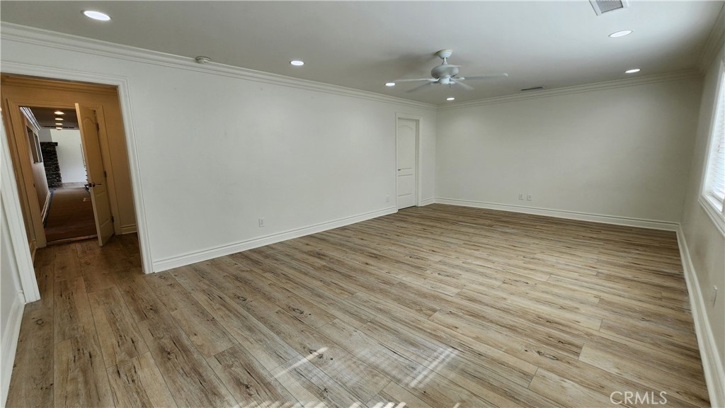 5845 Hilltop Road Hidden Hills, CA 91302 - Photo 13 of 20 a view of an empty room with wooden floor and a window