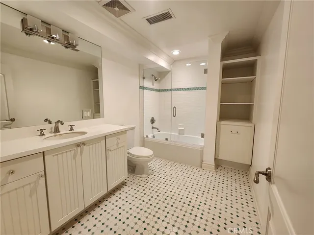 a bathroom with a sink a toilet and a shower