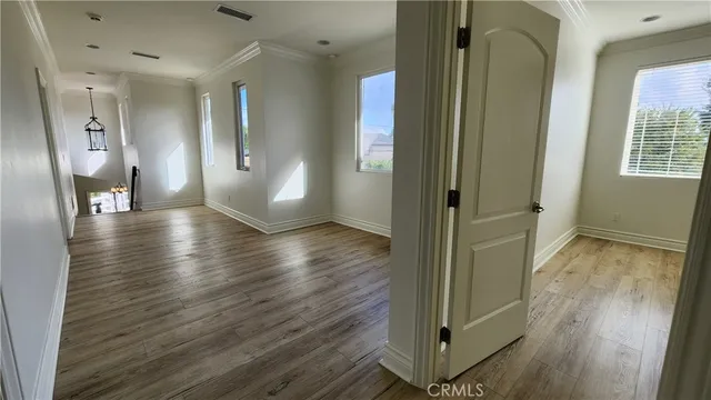 a view of a hallway with wooden floor