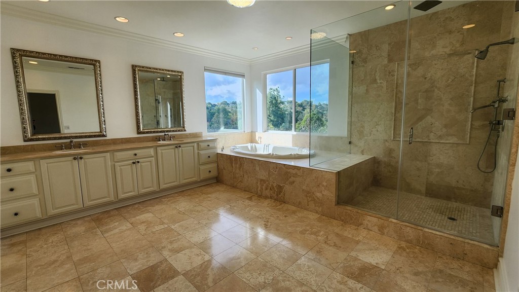 5845 Hilltop Road Hidden Hills, CA 91302 - Photo 17 of 20 a spacious bathroom with a mirror a shower and a sink