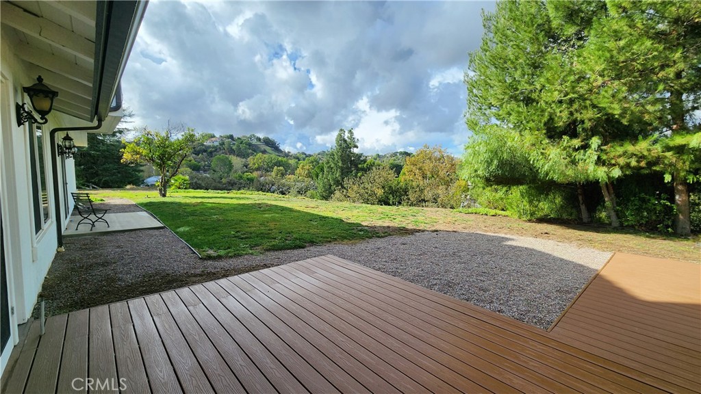 5845 Hilltop Road Hidden Hills, CA 91302 - Photo 18 of 20 a view of a backyard with wooden floor