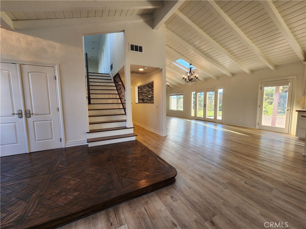 5845 Hilltop Road Hidden Hills, CA 91302 - Photo 3 of 20 a view of a hallway with wooden floor and stairs