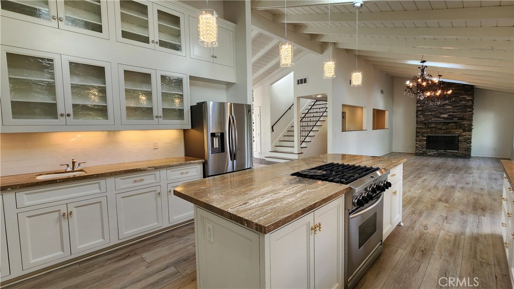 5845 Hilltop Road Hidden Hills, CA 91302 - Photo 7 of 20 a kitchen with granite countertop a sink stove and refrigerator
