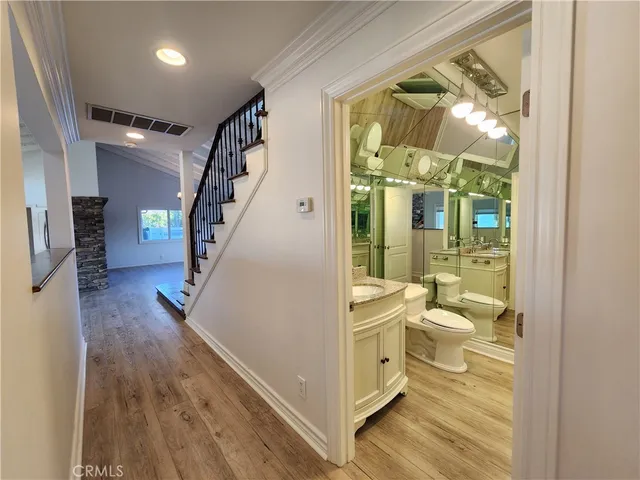 a bathroom with a toilet sink and a mirror