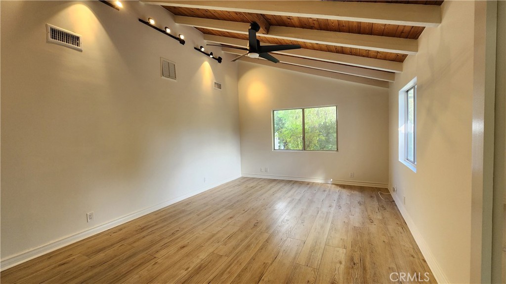 5845 Hilltop Road Hidden Hills, CA 91302 - Photo 9 of 20 a view of a room with wooden floor a ceiling fan and windows