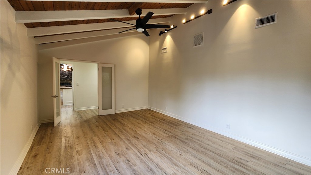 5845 Hilltop Road Hidden Hills, CA 91302 - Photo 10 of 20 a view of a room with wooden floor a ceiling fan and window