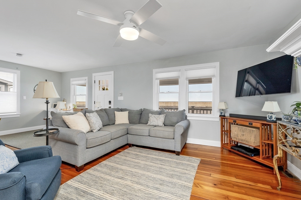 713 Ocean Boulevard Hampton, NH 03842 - Photo 15 of 42 a living room with furniture a flat screen tv and kitchen view
