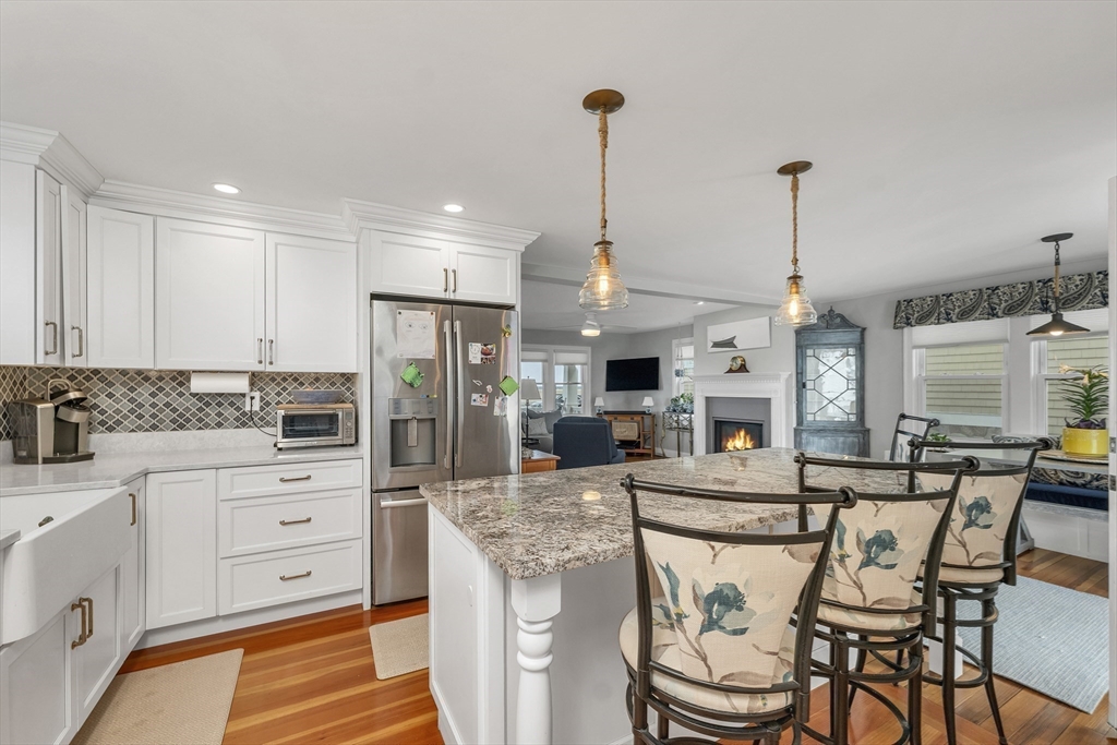713 Ocean Boulevard Hampton, NH 03842 - Photo 22 of 42 a view of a kitchen with kitchen island stainless steel appliances a stove a table and chairs