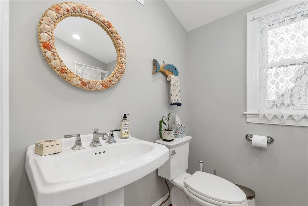 713 Ocean Boulevard Hampton, NH 03842 - Photo 24 of 42 a bathroom with a toilet sink and mirror