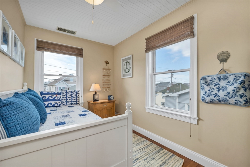 713 Ocean Boulevard Hampton, NH 03842 - Photo 29 of 42 a bedroom with a bed and a window with outer view