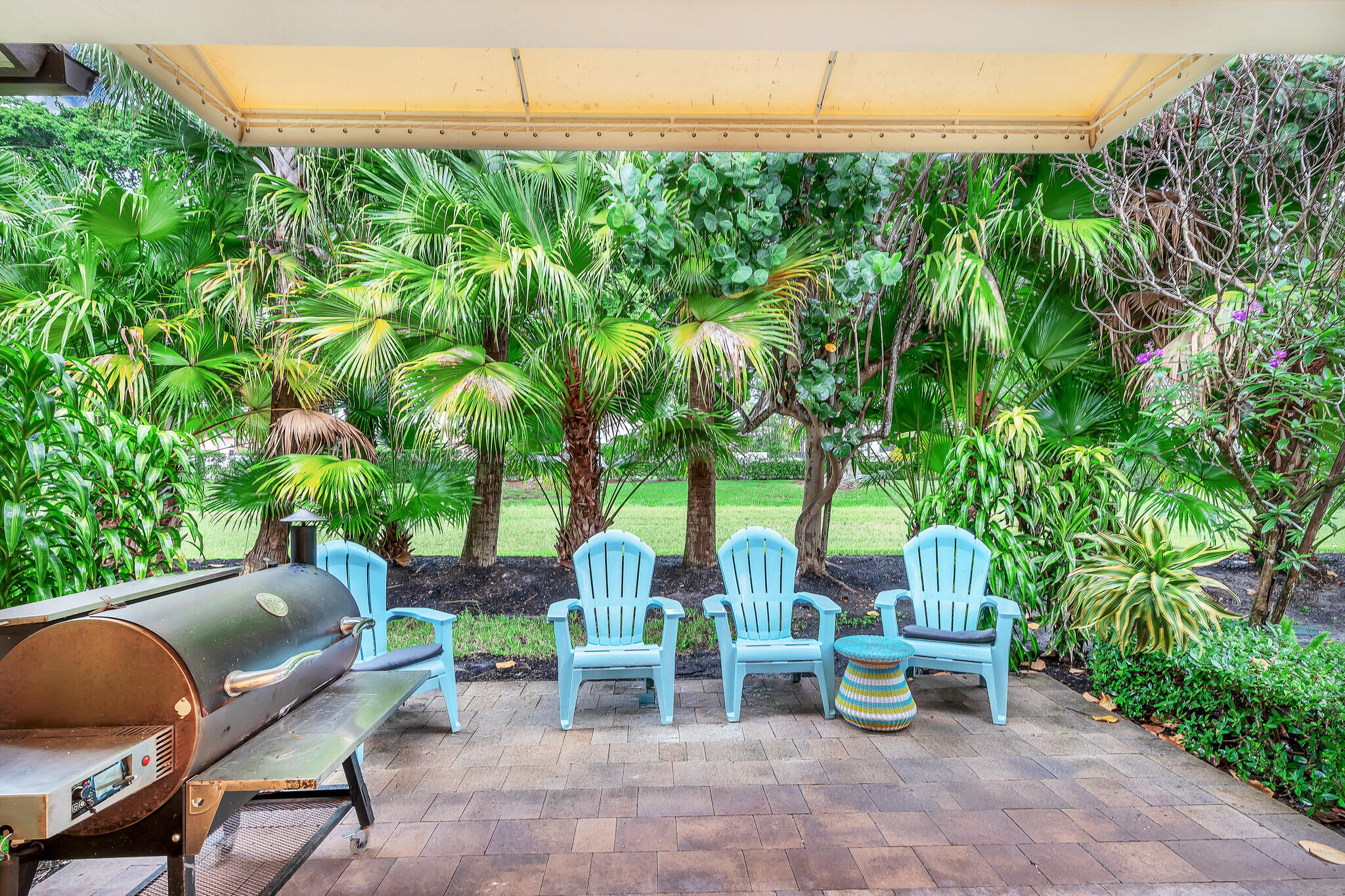 23008 Clear Echo Drive, Unit 11 Boca Raton, FL 33433 - Photo 28 of 64 a view of a chairs and table in a backyard