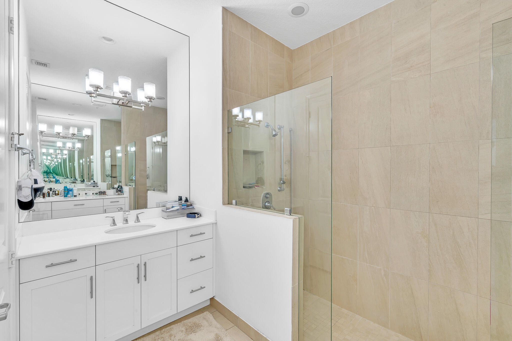 23008 Clear Echo Drive, Unit 11 Boca Raton, FL 33433 - Photo 34 of 64 a bathroom with a double vanity sink mirror and a shower