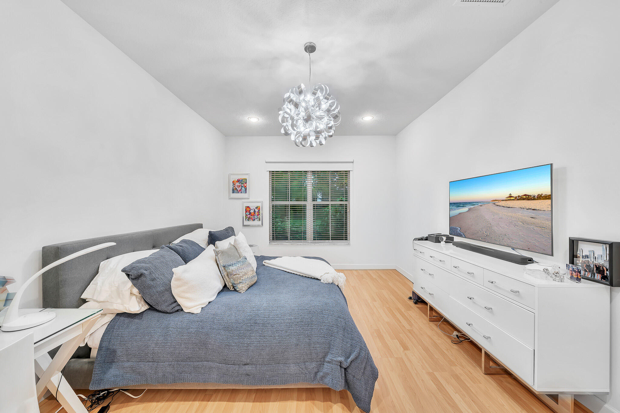 23008 Clear Echo Drive, Unit 11 Boca Raton, FL 33433 - Photo 36 of 64 a bedroom with a bed and flat screen tv