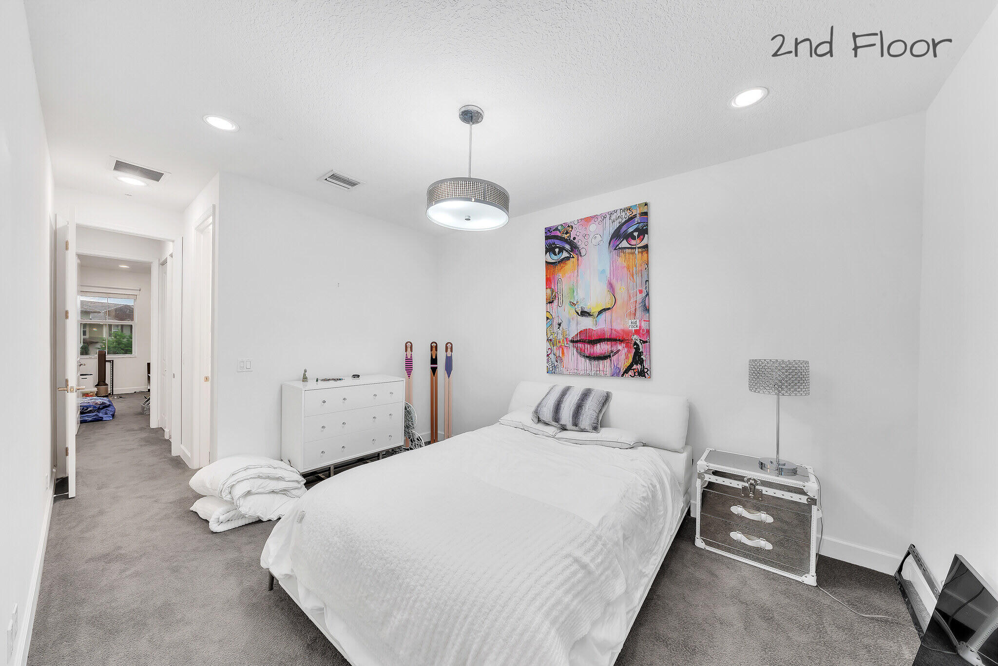 23008 Clear Echo Drive, Unit 11 Boca Raton, FL 33433 - Photo 48 of 64 a bedroom with a bed and a chandelier