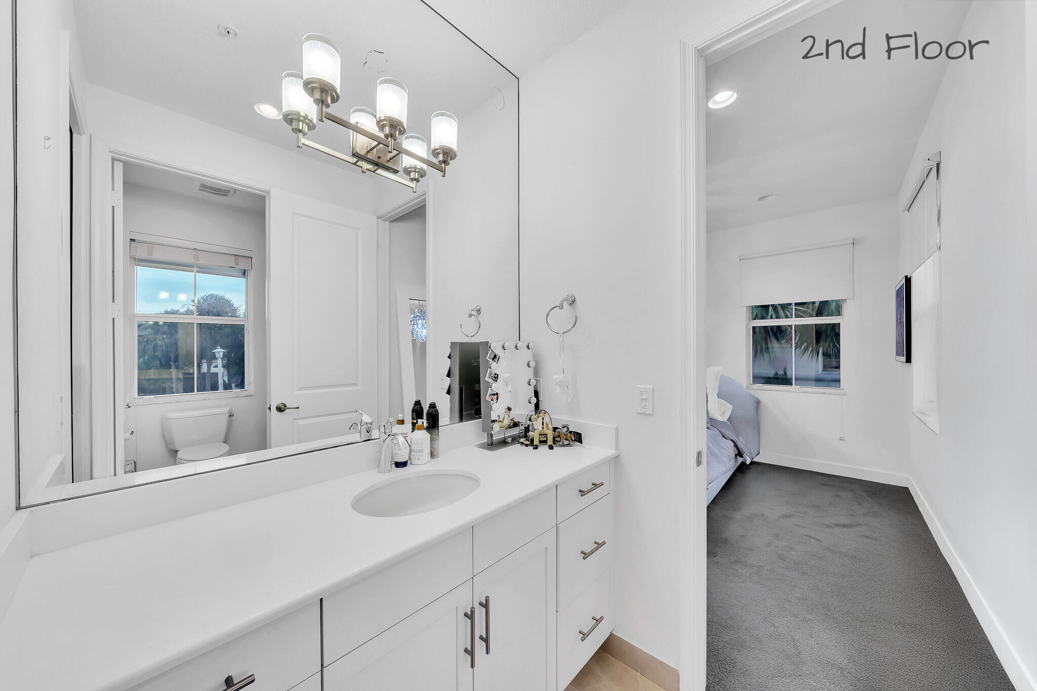 23008 Clear Echo Drive, Unit 11 Boca Raton, FL 33433 - Photo 53 of 64 a bathroom with a sink double vanity and a mirror