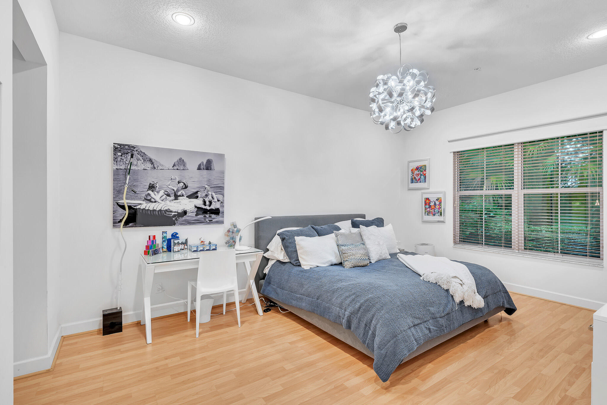 23008 Clear Echo Drive, Unit 11 Boca Raton, FL 33433 - Photo 8 of 64 a spacious bedroom with a bed and a chandelier