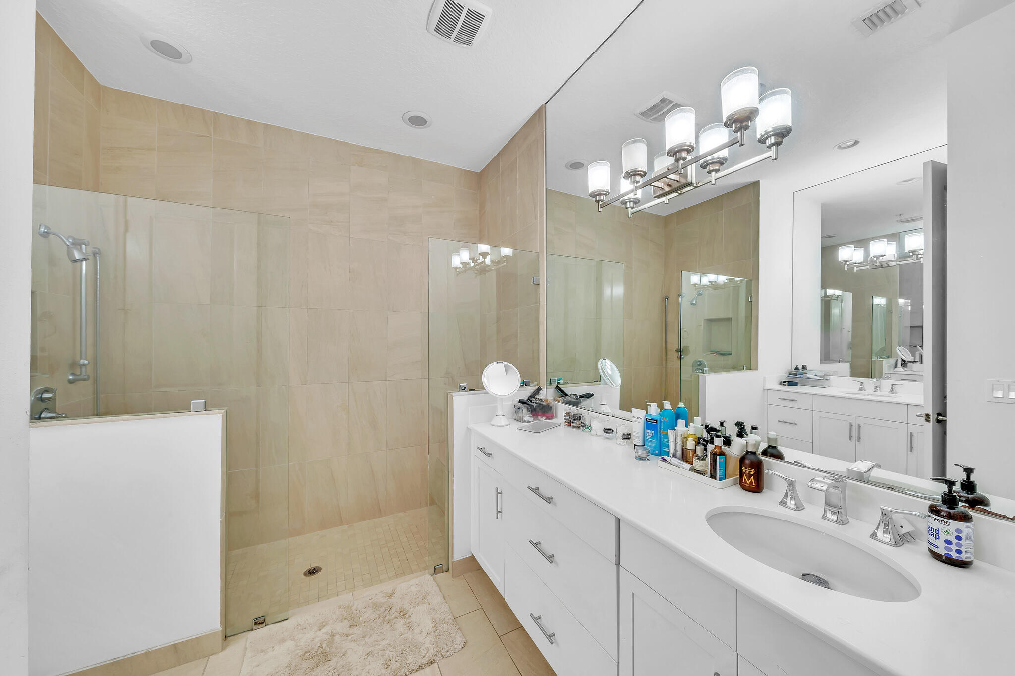 23008 Clear Echo Drive, Unit 11 Boca Raton, FL 33433 - Photo 9 of 64 a bathroom with a sink double vanity granite tub shower and a mirror
