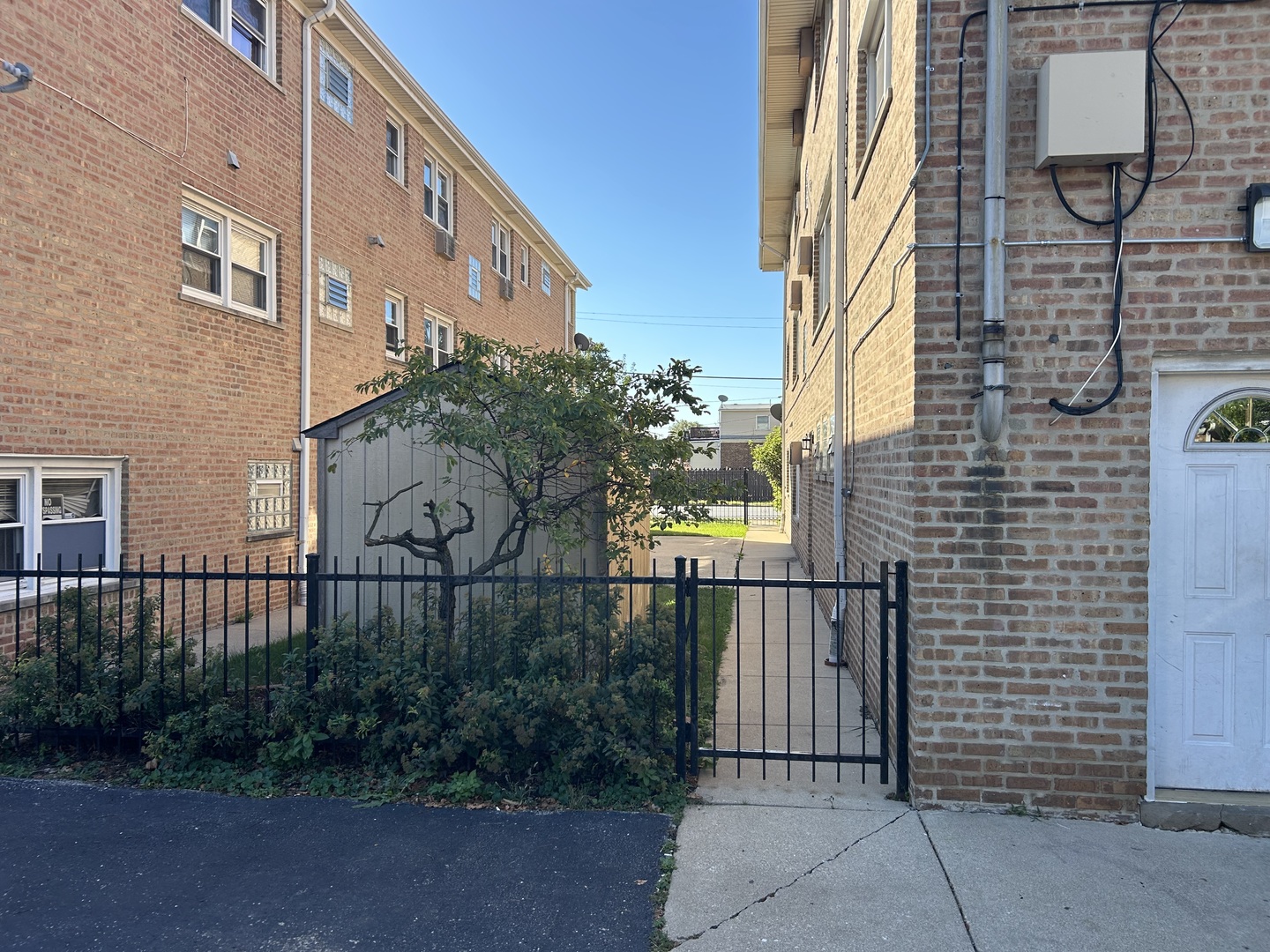 3820 West 47th Street, Unit 2NE Chicago, IL 60632 - Photo 2 of 6 a brick building with a street sign on the side of it