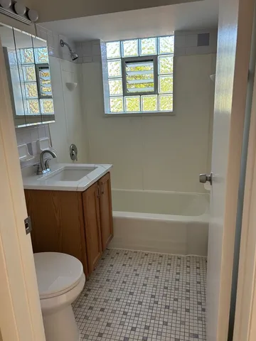 a bathroom with a sink a toilet and a bathtub