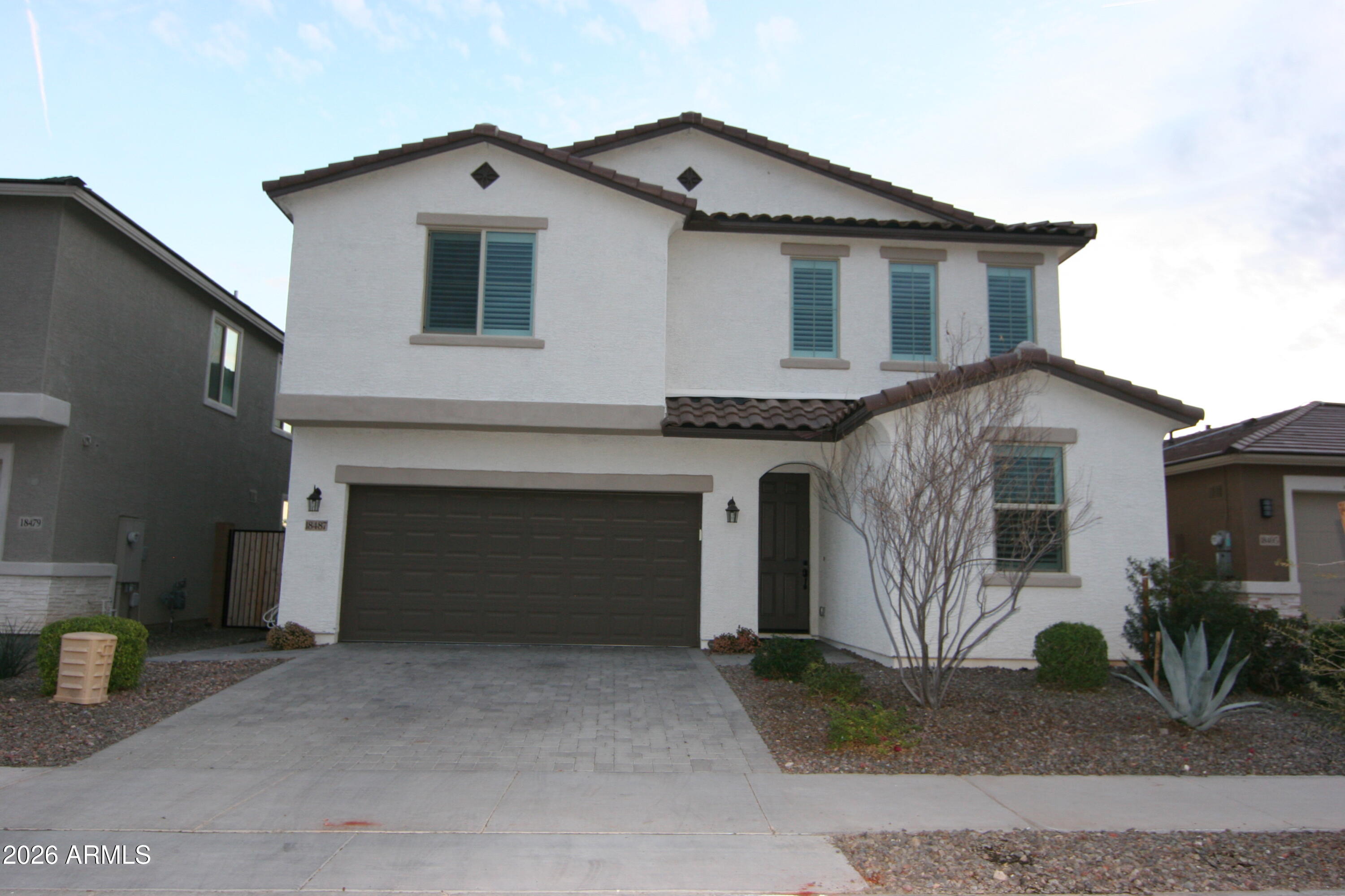 18487 West Ipswitch Way Surprise, AZ 85374 - Photo 1 of 36 a front view of a house with a yard and garage