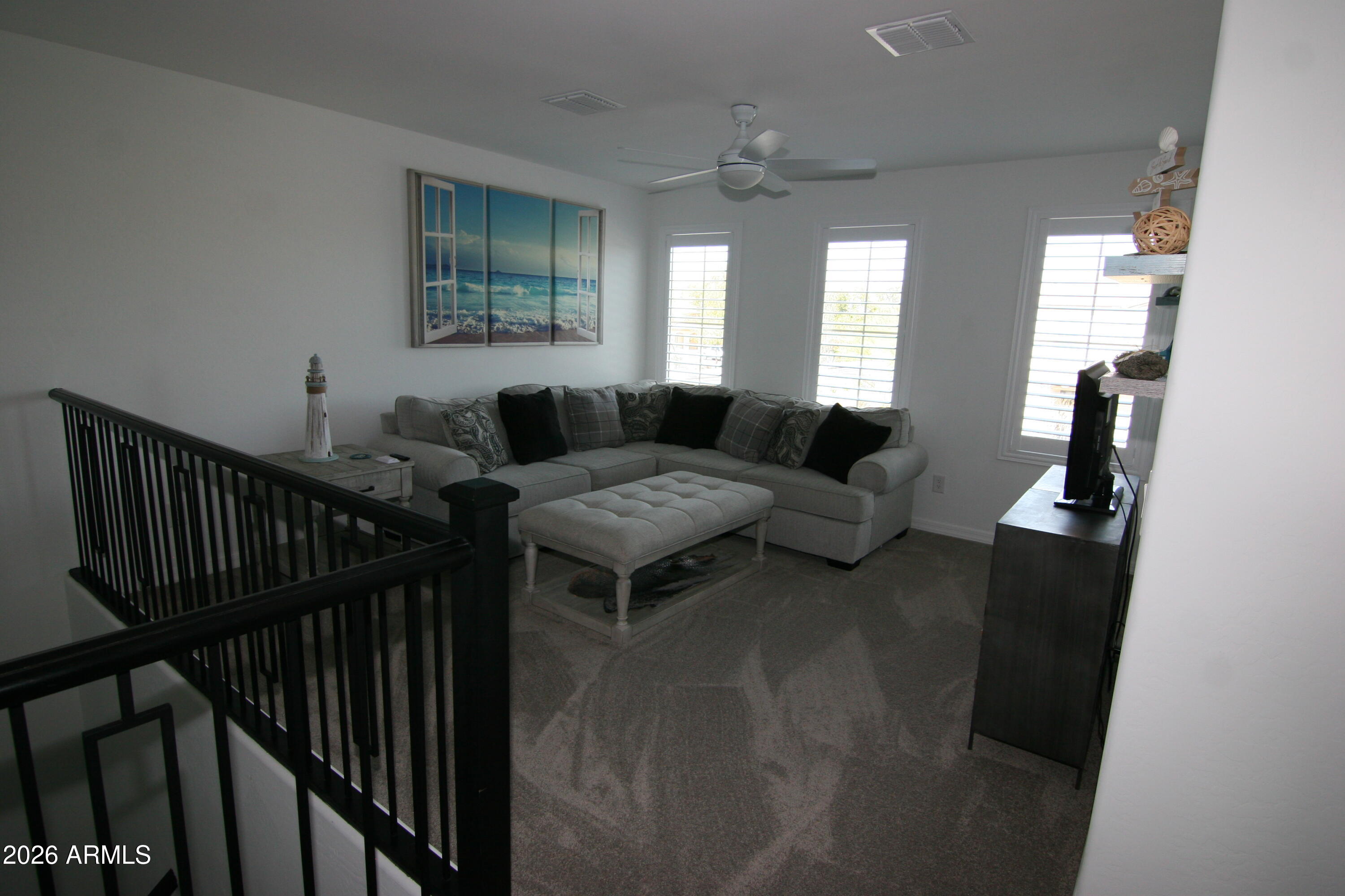 18487 West Ipswitch Way Surprise, AZ 85374 - Photo 11 of 36 a living room with furniture and wooden floor