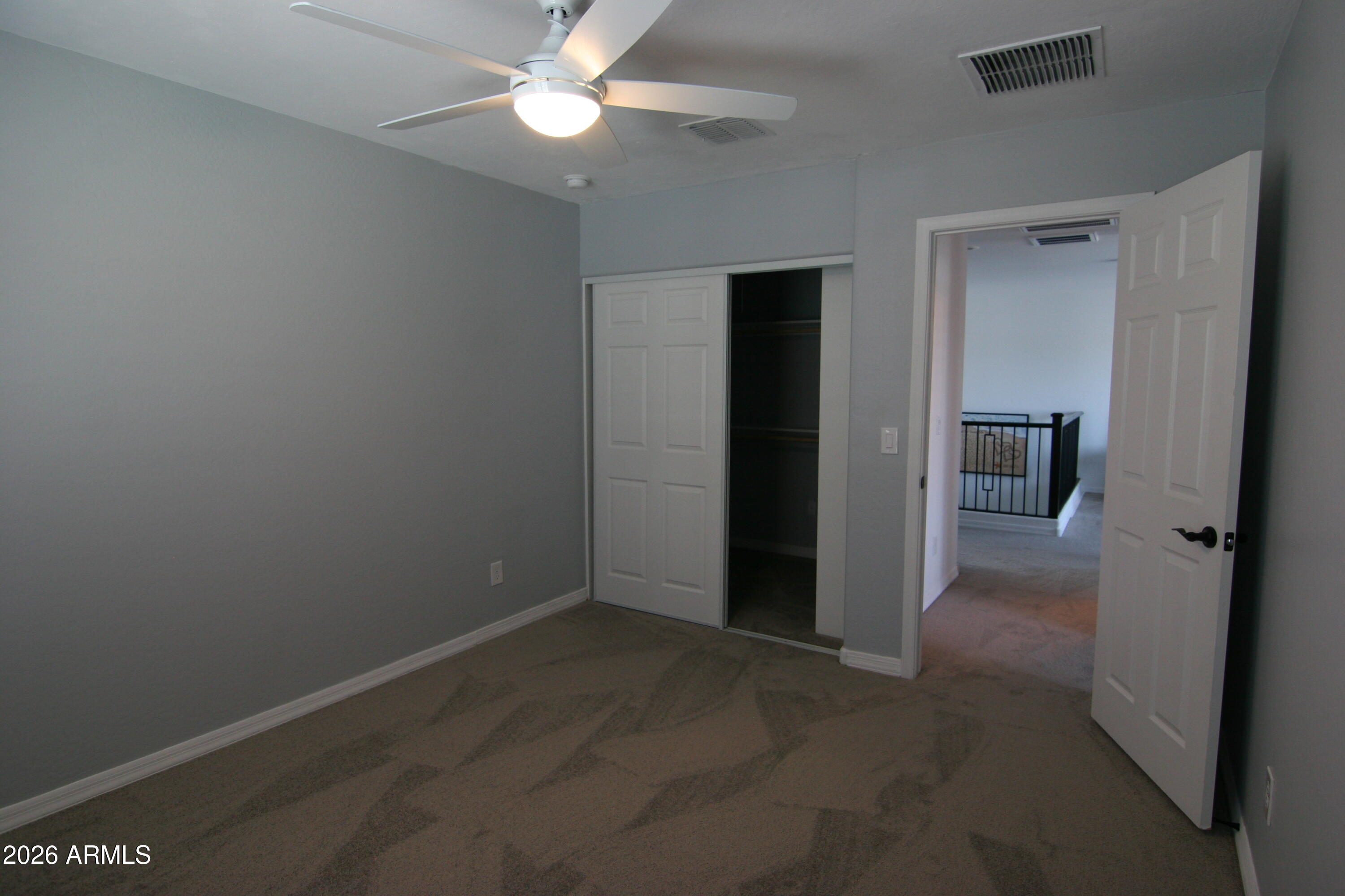 18487 West Ipswitch Way Surprise, AZ 85374 - Photo 14 of 36 an empty room with fan and entrance