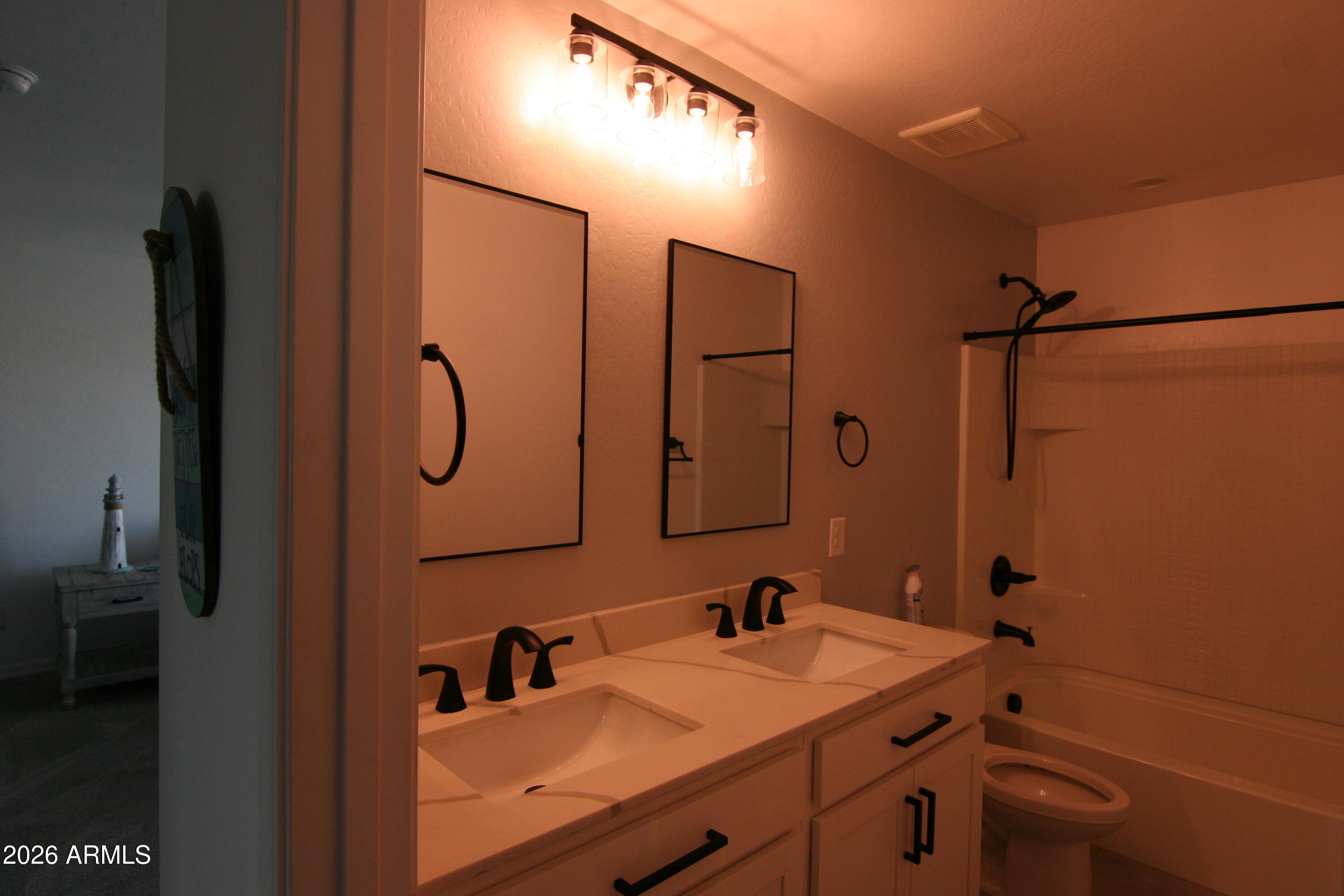 18487 West Ipswitch Way Surprise, AZ 85374 - Photo 16 of 36 a bathroom with a sink and mirror