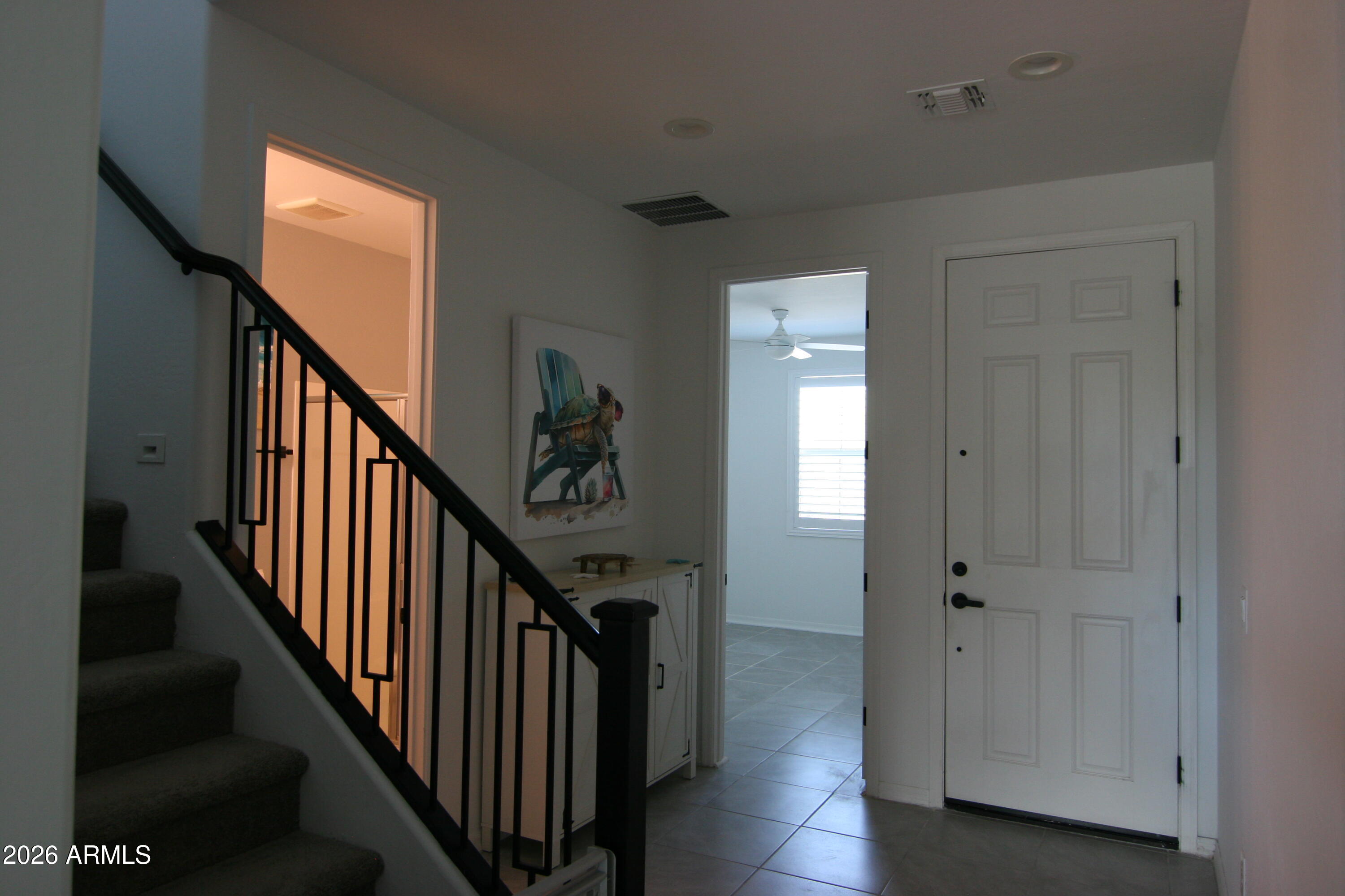18487 West Ipswitch Way Surprise, AZ 85374 - Photo 18 of 36 a view of a hallway with wooden floor and stairs