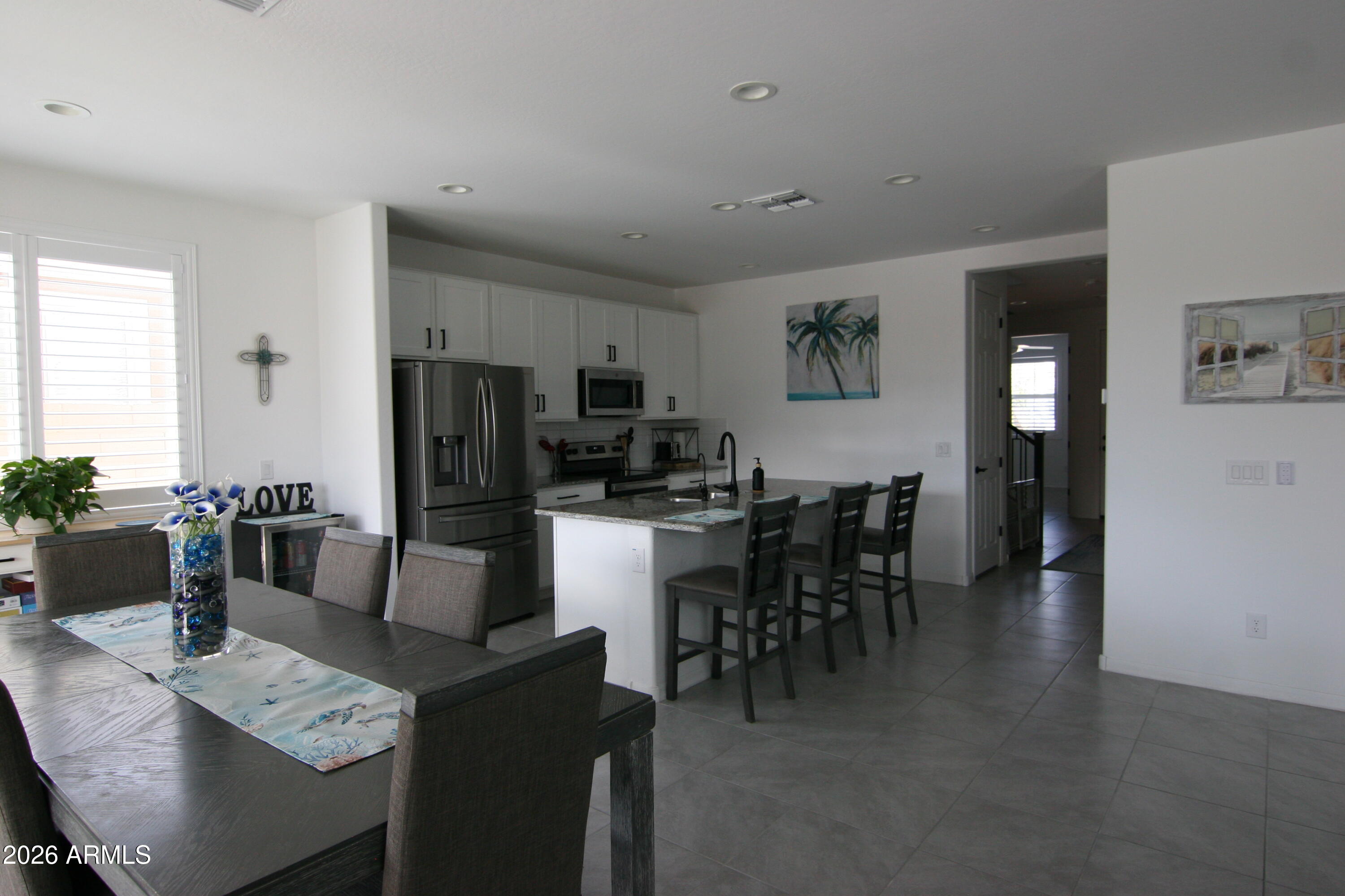 18487 West Ipswitch Way Surprise, AZ 85374 - Photo 3 of 36 a dining room with furniture and wooden floor