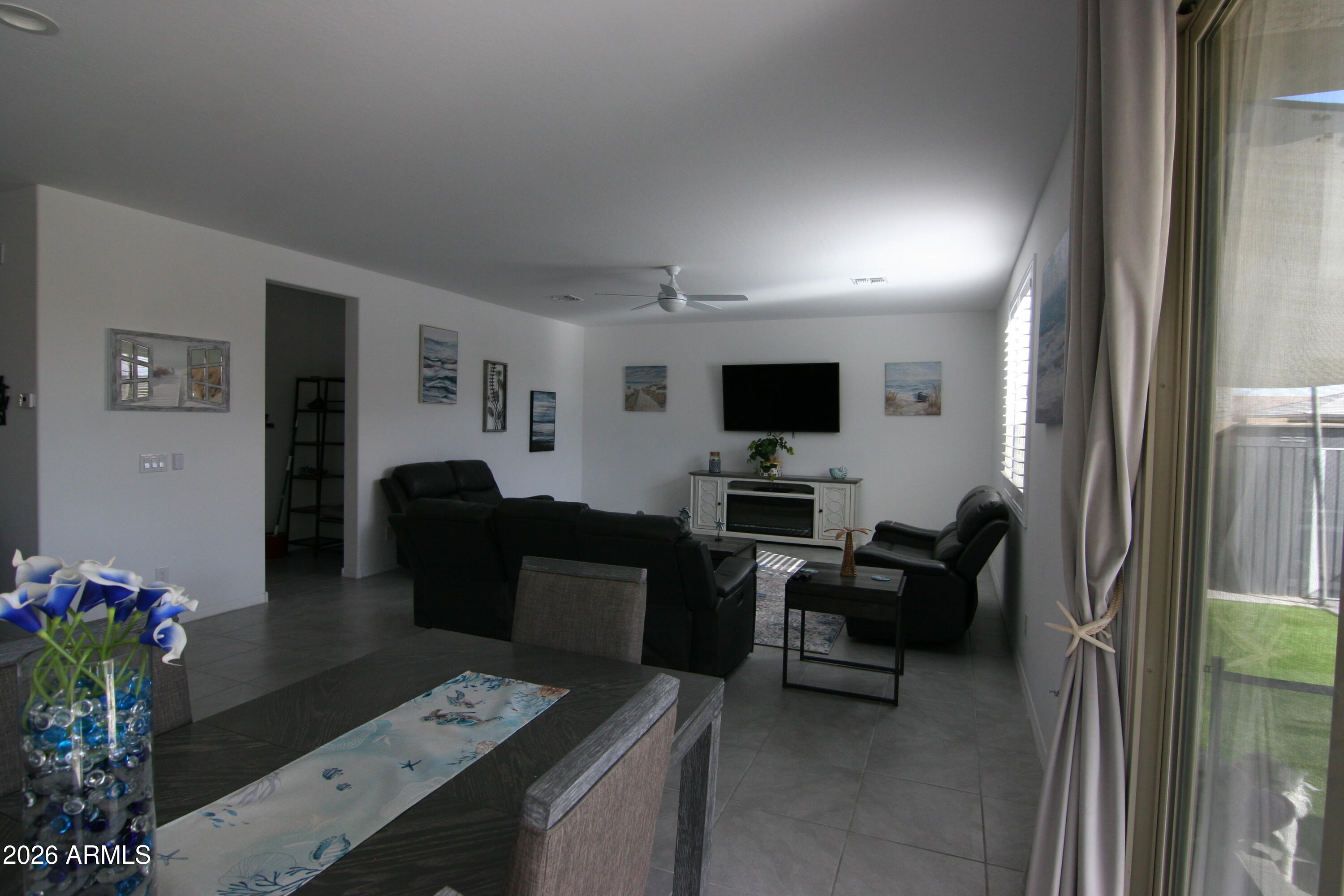 18487 West Ipswitch Way Surprise, AZ 85374 - Photo 4 of 36 a living room with furniture and a flat screen tv